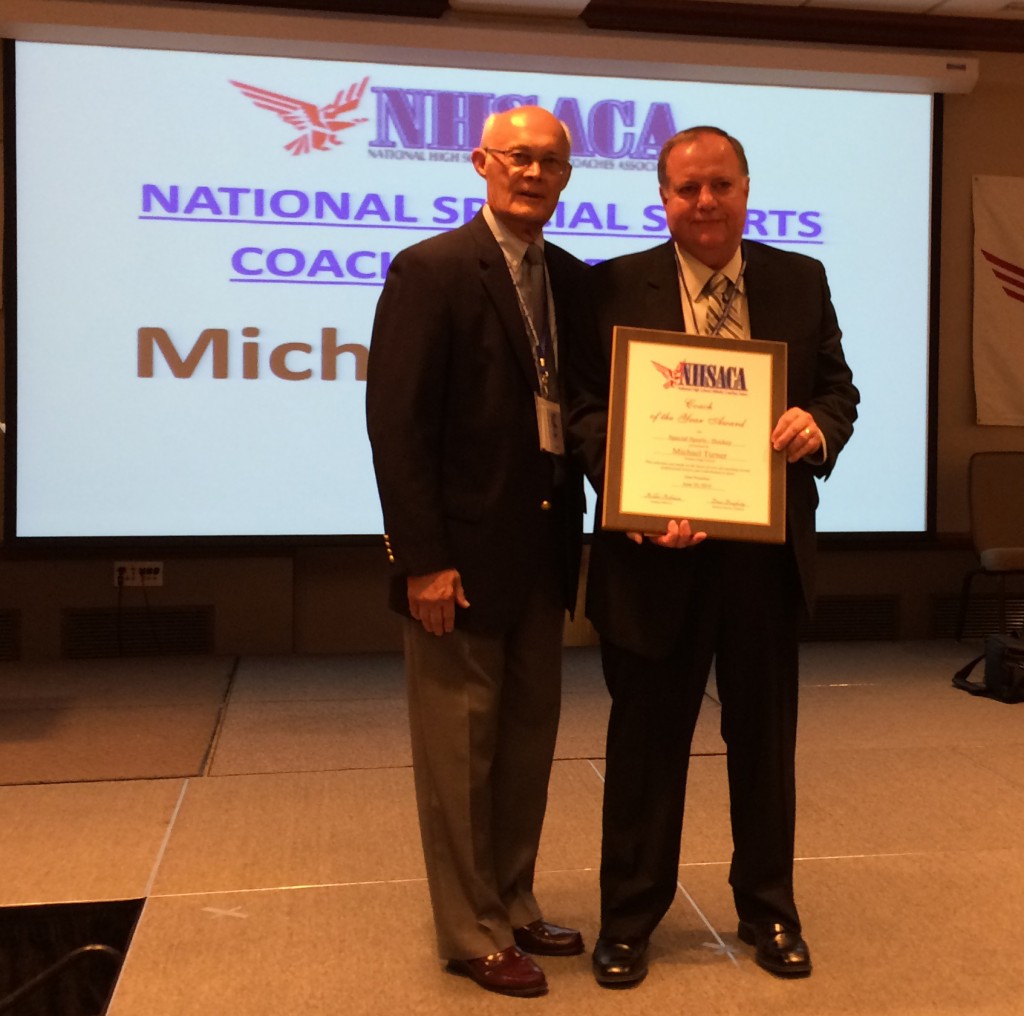 Turner accepts his national coach of the year plaque (photo courtesy of the MIHL)