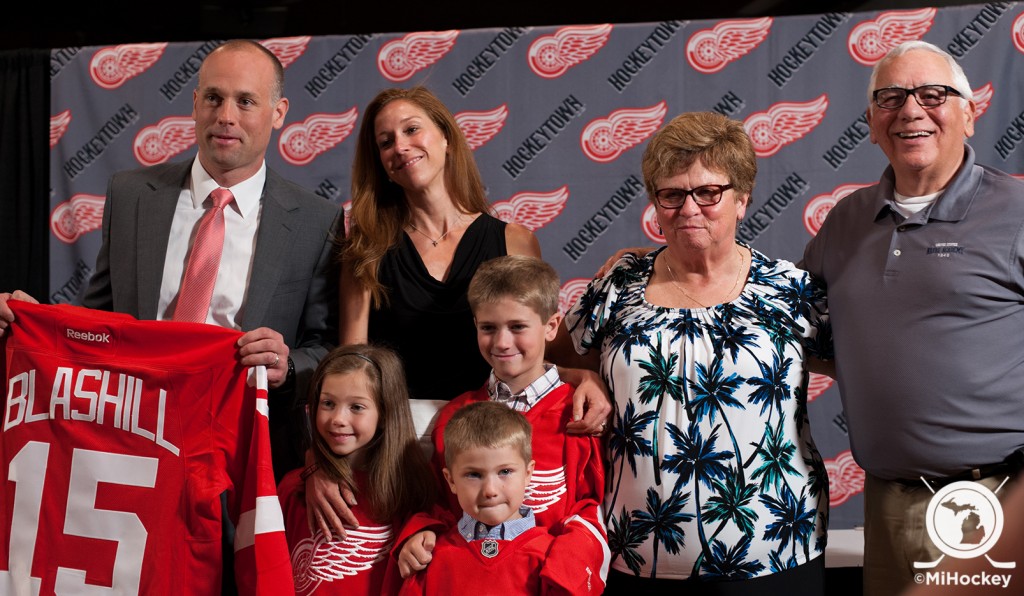 Jeff Blashill joined on stage by his wife, Erica, his children Teddy, Josie and Owen, and his parents, Jim and Rosemary. (Photo by Jen Hefner/MiHockey)