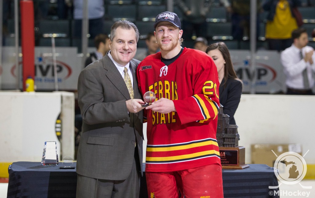 Ferris State's Gerald Mayhew with WCHA commissioner Bill Robertson to collect his all-tournament team trophy. (Photo by Michael Miller/MiHockey)